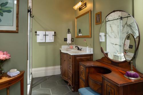 a bathroom with a sink and a mirror at Inn at Woodhaven-In the Heart of the Bourbon Trail-Over 12 Distilleries Nearby in Louisville