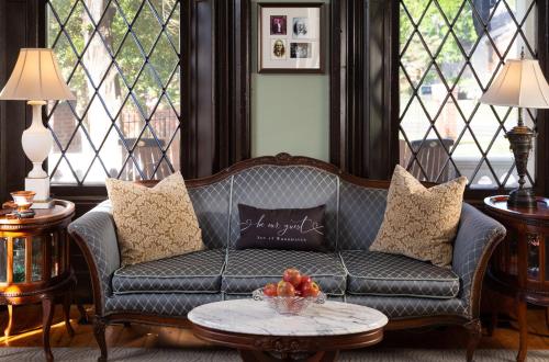 a living room with a couch and a table at Inn at Woodhaven-In the Heart of the Bourbon Trail-Over 12 Distilleries Nearby in Louisville