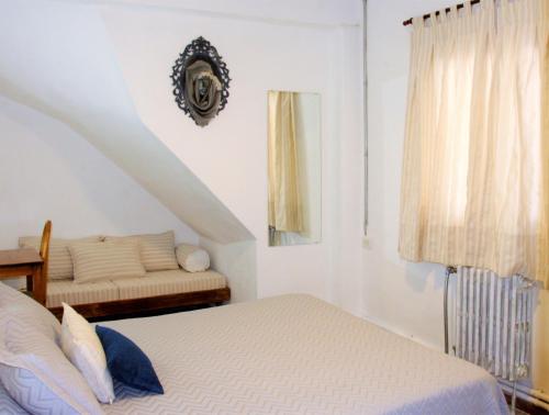 a white bedroom with a bed and a window at Hotel Medina B&B in Mar del Plata