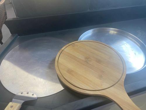 a wooden spoon sitting next to a metal pan at Pousada Recanto Forte in Florianópolis