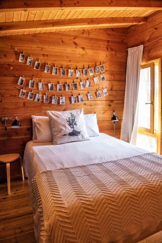 a bedroom with a bed and a wooden wall at Bungalow B1 em Fão - Ofir by Ana Ferro Rentals in Ofir