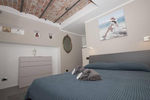 a bedroom with a blue bed and a dresser at Il mare dietro l'angolo in Varazze
