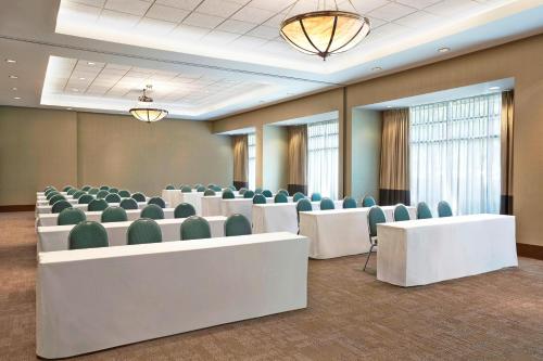 a conference room with white tables and green chairs at Grand Park Hotel Vancouver Airport, an Ascend Collection Hotel in Richmond