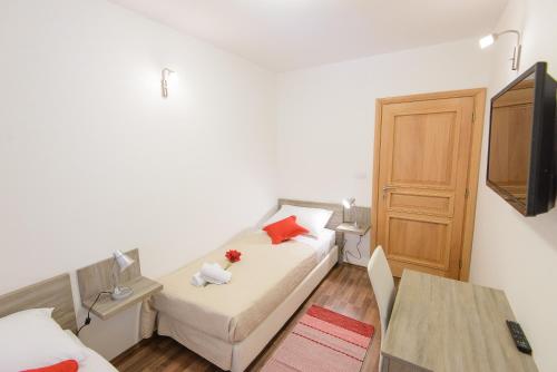 a small room with a bed and a table at Apartment Violeta 1 with private terrace in Dubrovnik
