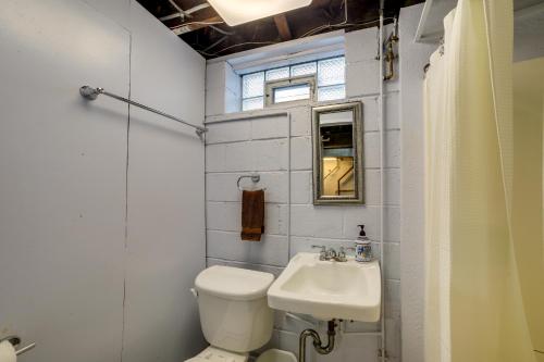 a small bathroom with a toilet and a sink at Peaceful Pittsburgh Townhome with Large Yard in Pittsburgh