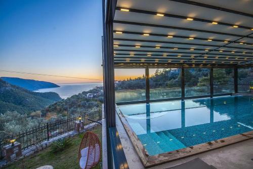 a house with a swimming pool with a view at Kalabantia House in Fethiye