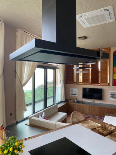 a kitchen with a stove top oven above a living room at Hestia View in Fethiye