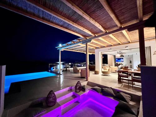 a living room with purple lighting in a house at New Serenity Art Villa Elounda in Elounda