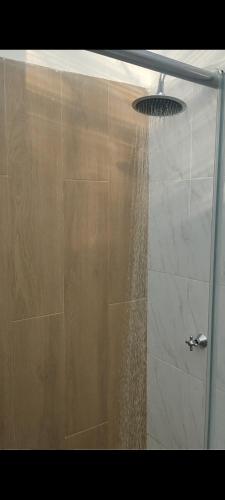 a shower with a shower head with water coming out of it at Glamping MINKAWAY in Santa Marta
