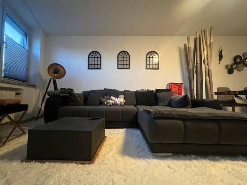 a living room with a couch and a table at Modernes Apartment mit 75qm mit Balkon & Aussicht in Aachen