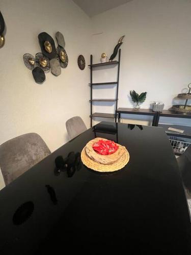 a black table with a pizza on top of it at Modernes Apartment mit 75qm mit Balkon & Aussicht in Aachen