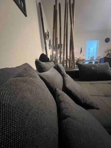 a couch with pillows in a living room at Modernes Apartment mit 75qm mit Balkon & Aussicht in Aachen