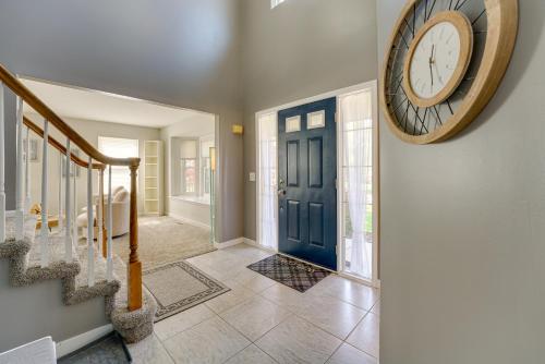 a large clock on a wall next to a hallway at Pet-Friendly Vacation Rental in Wixom with Hot Tub! in Wixom