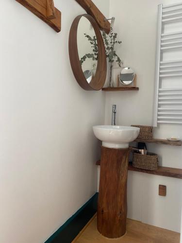 a bathroom with a sink and a mirror on the wall at La Vieille Eglise in Le Hohwald