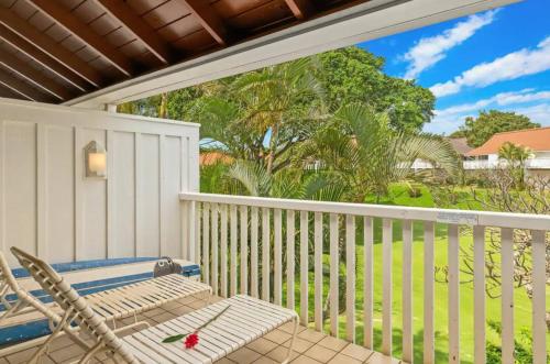 a porch with a chair and a view of the ocean at Kiahuna Plantation Unit 42, Air Conditioning, 2 Minute Walk to Beach in Koloa