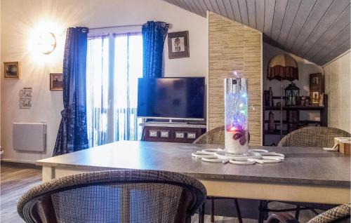 a dining room table with a vase on top of it at Nice Apartment In Excenevex With Wifi in Excénevex