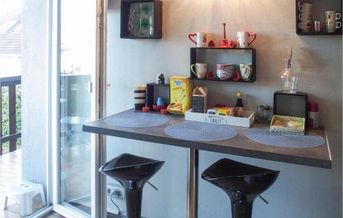 a counter with two stools in a kitchen at Nice Apartment In Excenevex With Wifi in Excénevex
