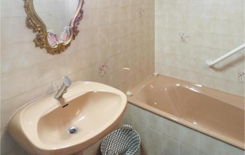 a bathroom with a sink and a bath tub at 1 Bedroom Stunning Apartment In Excenevex in Excénevex