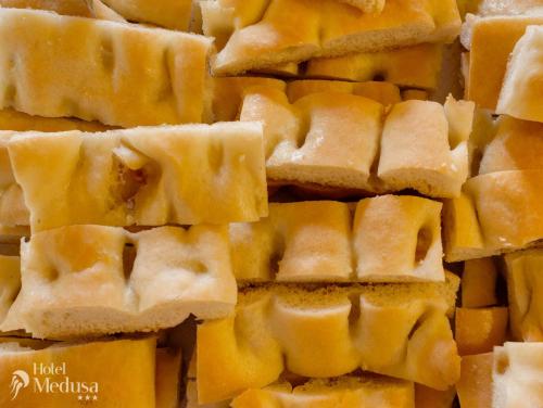 a pile of cheese braid bread cut into pieces at Hotel Medusa in Finale Ligure