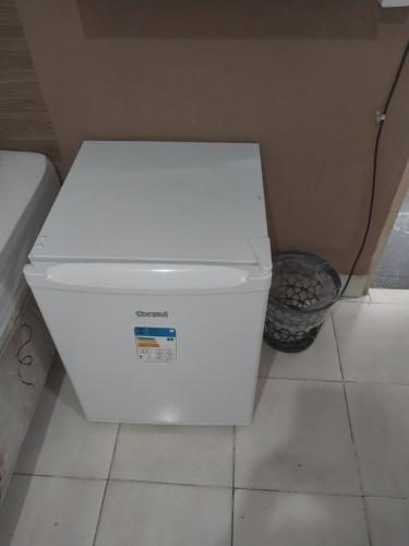 a white cooler sitting on the floor in a room at Aparecida Akuto's Pousada in Aparecida
