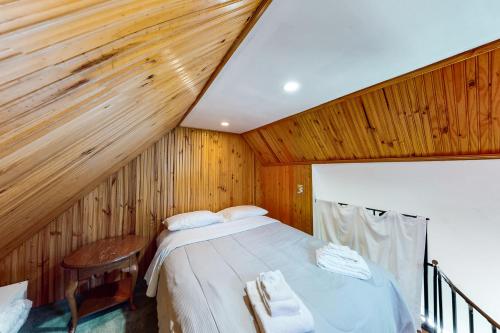 una camera con letto e parete in legno di Osprey View Villa a Dennis