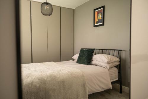 a small bedroom with a bed and a mirror at Rose Hill in Shrewsbury