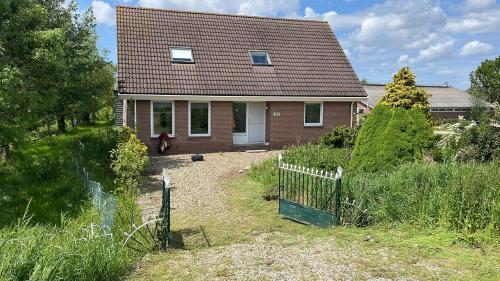 a house with a fence in front of it at Guesthouse at the Amstel river with 2BR 2BA and garden in Amstelveen