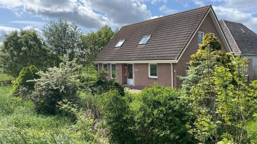 a brick house with a gambrel roof at Guesthouse at the Amstel river with 2BR 2BA and garden in Amstelveen