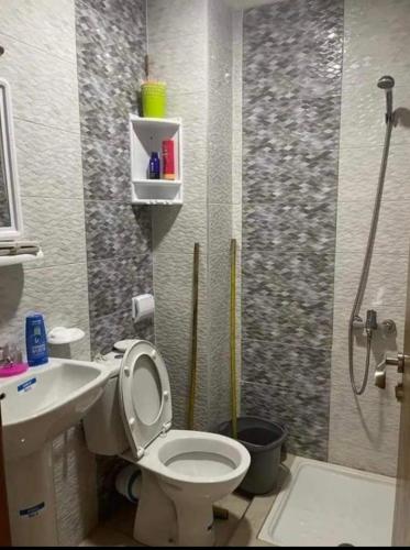 a bathroom with a shower and a toilet and a sink at Spacious 2-Bedroom Apartment in Martil