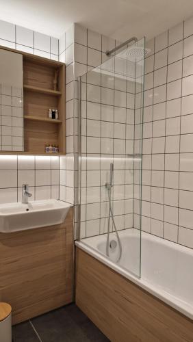 a bathroom with a shower and a tub and a sink at Luxury Apartment Birmingham in Birmingham