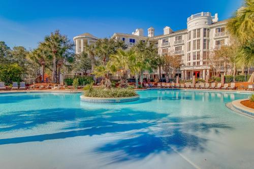 a swimming pool in front of a large building at The Grand #2703 in Destin