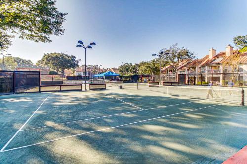 a tennis court with a person walking on it at The Grand #2703 in Destin
