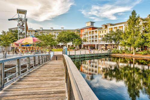 a wooden walkway next to a river with buildings at The Grand #2703 in Destin