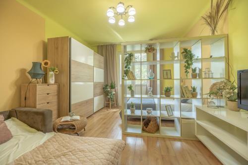 a bedroom with a bed and a room with plants at Apartament Premium Salt in Wieliczka