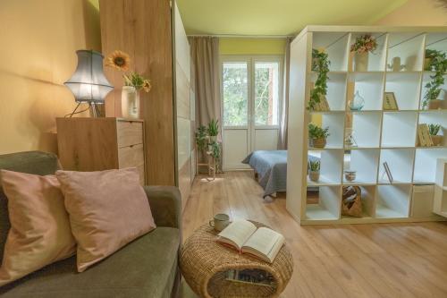 a living room with a couch and a book shelf at Apartament Premium Salt in Wieliczka
