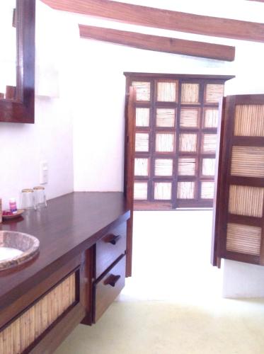 a bathroom with a wooden counter and a sink at Casa Flor de Mar in Zipolite