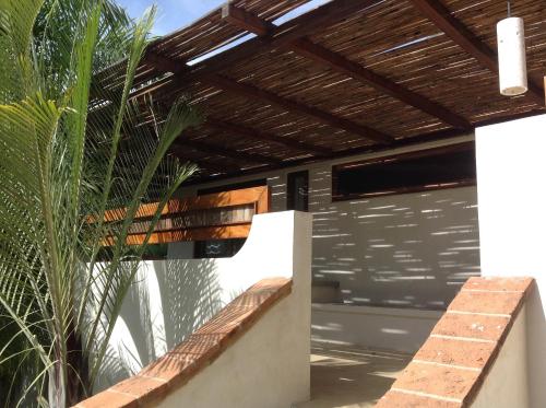 a wooden pergola on top of a house at Casa Flor de Mar in Zipolite
