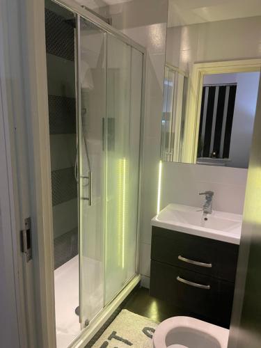 a bathroom with a shower and a sink and a toilet at Crossbrook street in Cheshunt