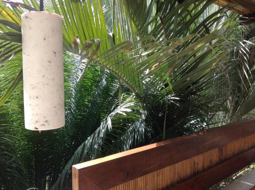 a white candle hanging over a wooden fence at Casa Flor de Mar in Zipolite