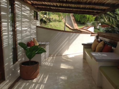 a patio with a potted plant on a porch at Casa Flor de Mar in Zipolite