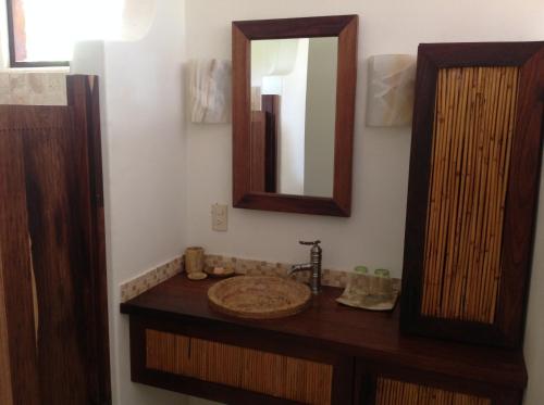 a bathroom with a sink and a mirror at Casa Flor de Mar in Zipolite