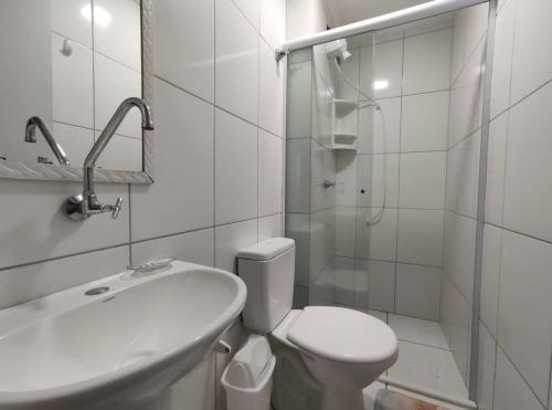 uma casa de banho com um WC, um lavatório e um chuveiro em Apto Ubatuba Home - Eloisa 114 em Ubatuba