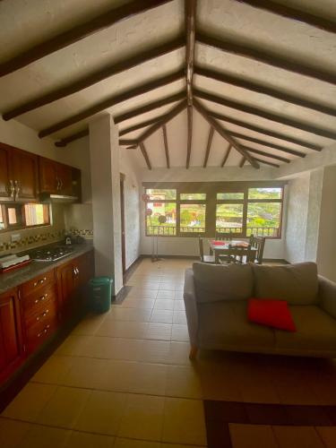 a living room with a couch and a table at Hospedaje Iraca - Pueblito Boyacense Duitama in Duitama