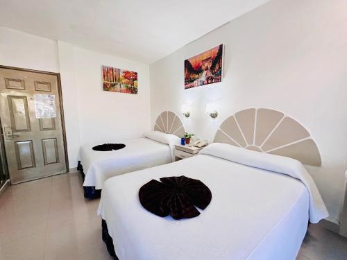 Una cama o camas en una habitación de Hotel Plaza Caribe