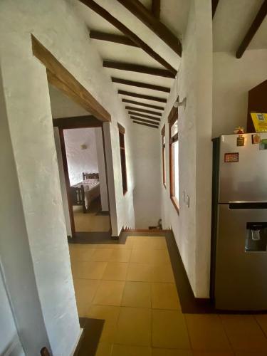a hallway of a house with a refrigerator at Hospedaje Iraca - Pueblito Boyacense Duitama in Duitama