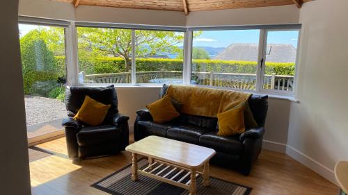 a living room with a couch and a table at Hill Sea View Cottage in Glengarriff