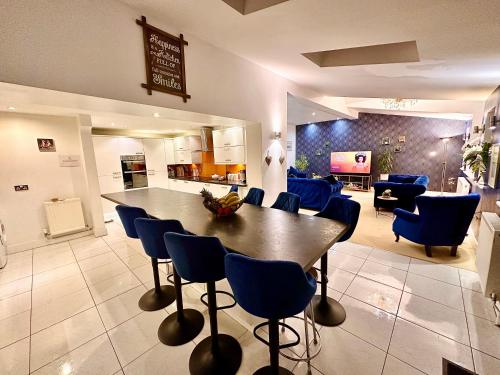 a living room with a large table and chairs at PENDERI HOUSE USK SOUTH WALES in Usk