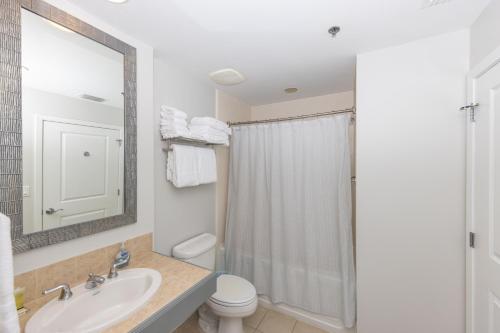 a bathroom with a sink and a toilet and a shower at Luau 6907 Sandestin Florida Beach Rentals 1 BR Tram included in Destin