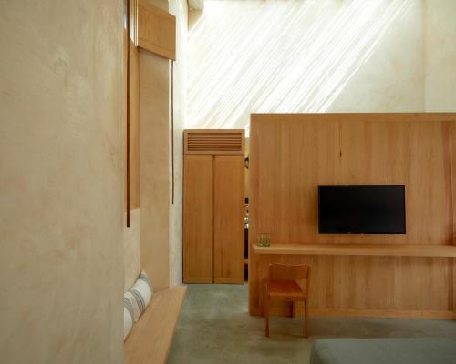 a living room with a television and a skylight at Hotel Escondido Oaxaca, a Member of Design Hotels in Oaxaca City