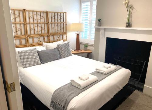 a bedroom with a large bed with towels on it at The Edward Townhouses 151 - 157 in Orange
